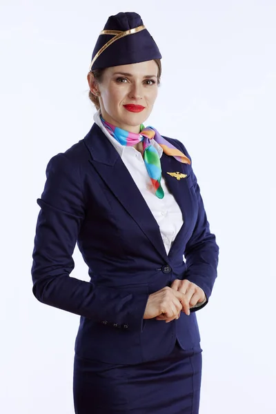 elegant air hostess woman against white background in uniform.