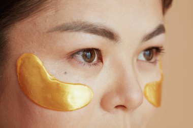 Closeup on woman with eye patches.