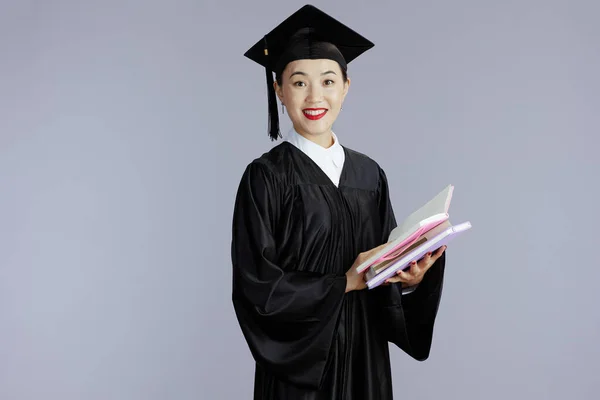 Happy Young Graduate Student Asian Woman Books Notebooks Gray Background — Stockfoto