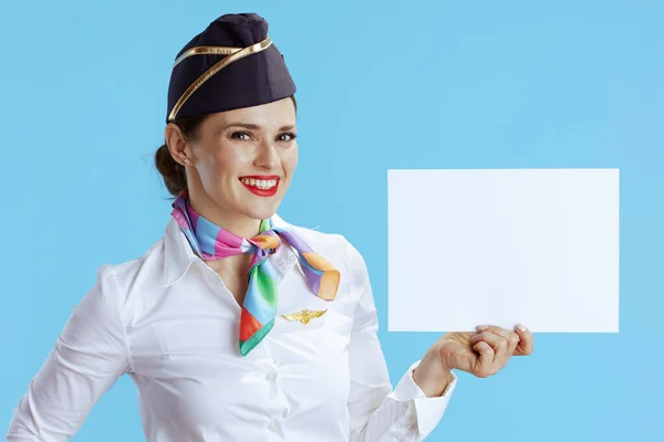 Happy Elegant Female Stewardess Blue Background Uniform Showing Blank Paper — Stock Photo, Image