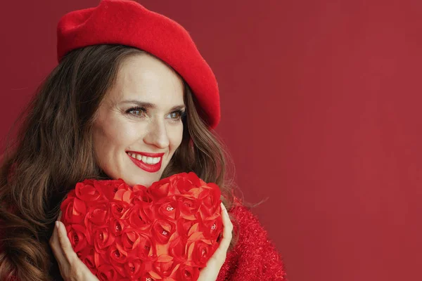 ハッピーバレンタイン 赤いセーターとベレー帽を着た現代的な中年女性の笑顔と赤いハート — ストック写真