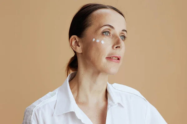 Modern Woman Eye Cream Face White Shirt Beige Background — Foto Stock