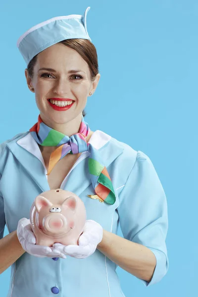 Smiling Modern Female Stewardess Blue Background Blue Uniform Piggy Bank — Stock Photo, Image
