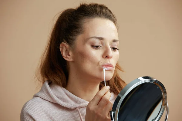 Woman Herpes Lips Mirror Applying Ointment Using Cotton Swab Beige — Stock Photo, Image