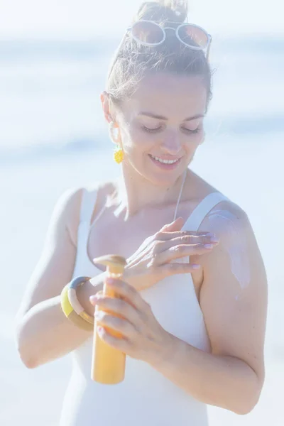 Happy Elegant Middle Aged Woman White Swimwear Beach Using Spf — Stock Photo, Image