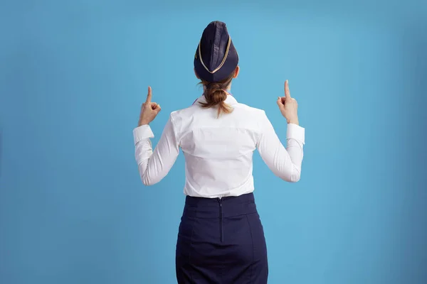 Seen Modern Female Air Hostess Blue Background Uniform Pointing — Stock Photo, Image