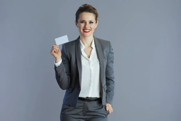 Happy Young Woman Worker Grey Suit Business Card Isolated Gray — Stock Photo, Image