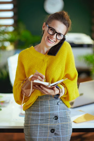 Happy Young Small Business Owner Woman Yellow Sweater Notebook Speaking — Stock Photo, Image