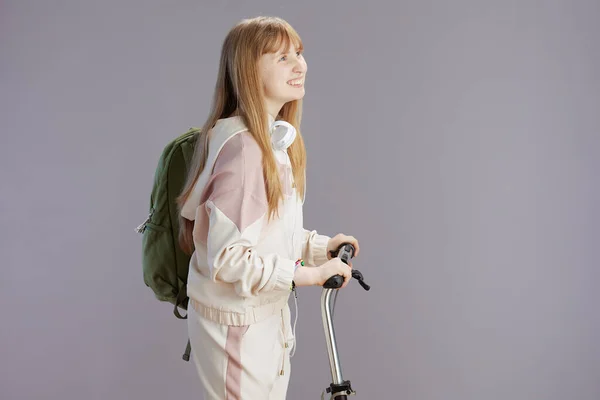 Smiling Trendy Young Woman Beige Tracksuit Backpack Headphones Scooter Isolated — Stock Photo, Image