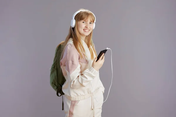 Heureuse Adolescente Moderne Survêtement Beige Avec Sac Dos Écoutant Musique — Photo