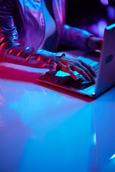 Neon metaverse futuristic concept. Closeup on woman with laptop.