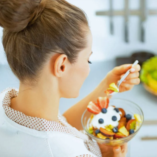 若い主婦は新鮮なフルーツサラダを食べる リアビュー — ストック写真
