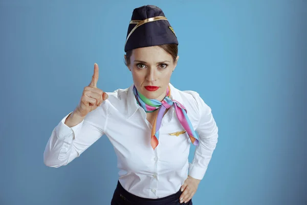 Modern Female Stewardess Blue Background Uniform Raised Finger Drawing Attention — Stock Photo, Image