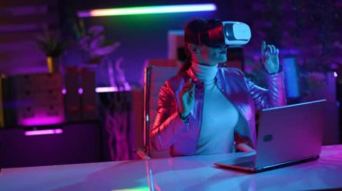 Neon metaverse futuristic concept. happy elegant female in virtual reality goggles designing virtual reality in modern office.