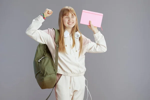 Smiling Modern Teen Girl Beige Tracksuit Backpack Workbooks Headphones Grey — Stock Photo, Image
