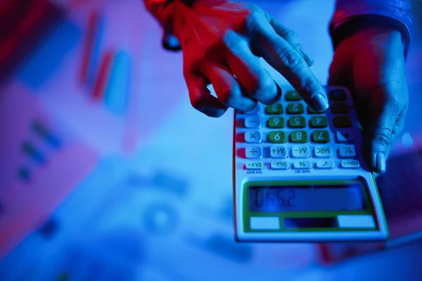 Closeup on modern woman with calculator.