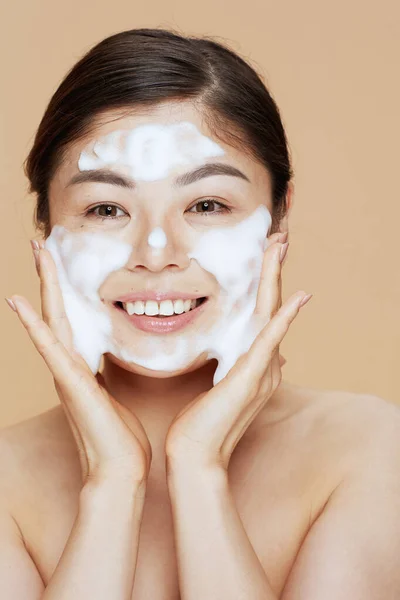 Portrait Young Asian Woman Washing Face Isolated Beige Background — Stock Photo, Image