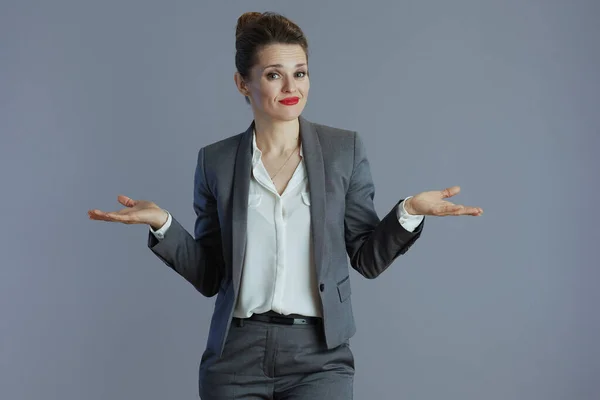 Doubting Trendy Female Worker Gray Suit Shrugging Shoulders Isolated Grey — Stock Photo, Image