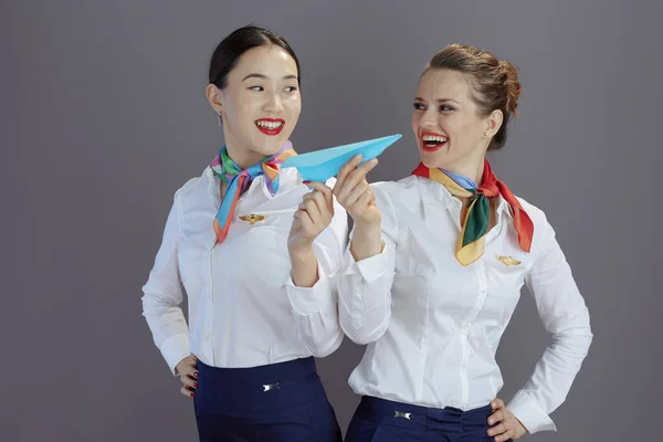 Uśmiechnięta Elegancka Stewardessa Niebieskiej Spódnicy Białej Koszuli Szaliku Papierowym Samolotem — Zdjęcie stockowe