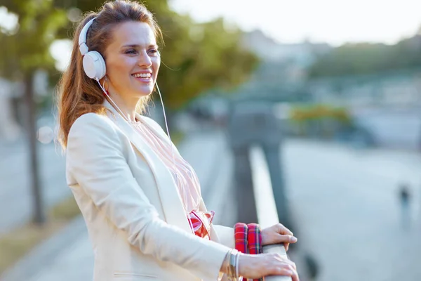 Smiling Trendy Woman Pink Dress White Jacket City Headphones — Stock Photo, Image