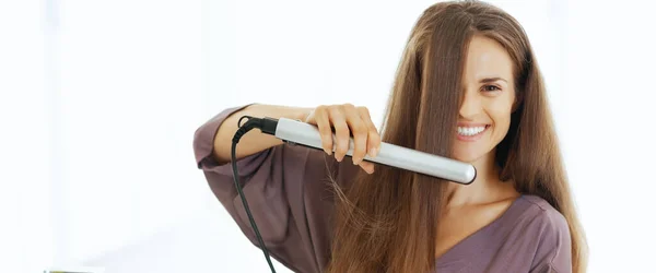 Happy Young Woman Straightening Hair Bathroom — Stock Photo, Image