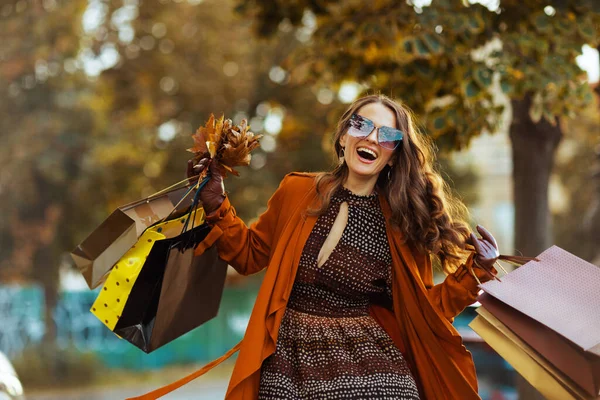 Hello October Smiling Stylish Woman Orange Trench Coat Shopping Bags — Stock Photo, Image