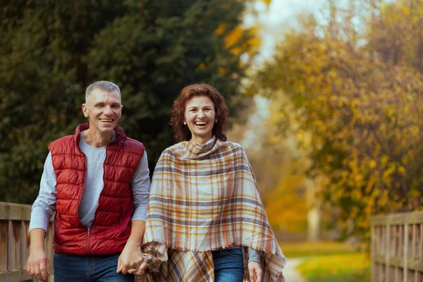 Hello autumn. smiling stylish couple in the park walking.