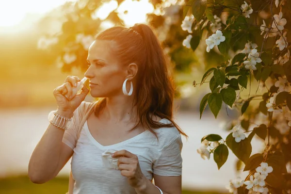 Summer Time Trendy Female White Shirt Using Nasal Spray Flowering — Stock Photo, Image