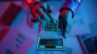 Closeup on modern female with calculator.