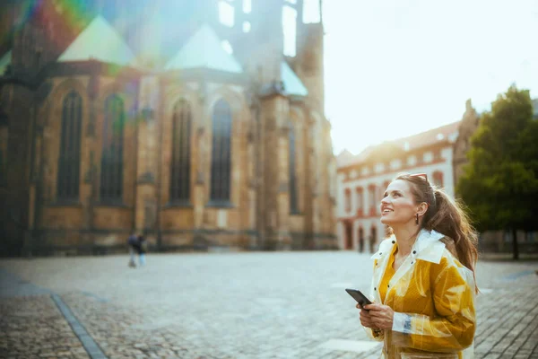 Smiling Young Traveller Woman Yellow Blouse Raincoat Prague Czech Republic — Stock Photo, Image