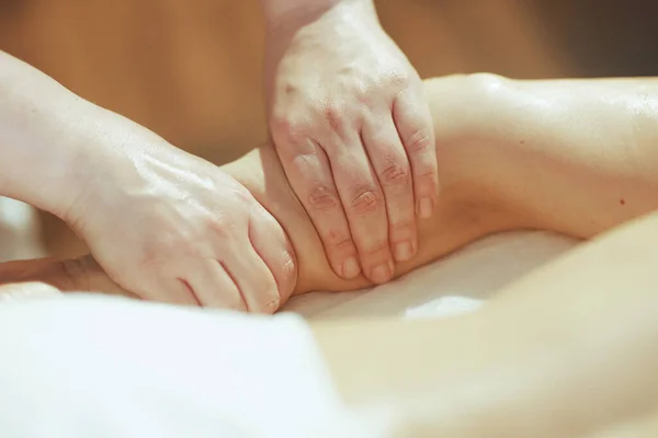 Healthcare time. Closeup on medical massage therapist in massage cabinet massaging clients arm.