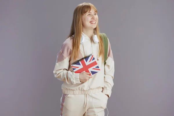 Happy Modern Girl Beige Tracksuit English Flag Workbook Headphones Isolated — Stock Photo, Image
