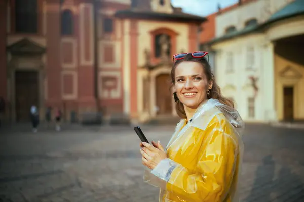 Happy Young Woman Yellow Blouse Raincoat Prague Czech Republic Using — Stock Photo, Image