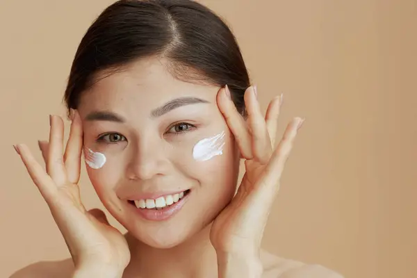 Portrait Young Asian Female Facial Cream Face Beige Background — Foto de Stock