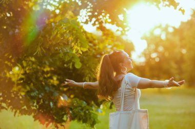 Yaz zamanı. 40 yaşında, beyaz gömlekli mutlu bir kadın..