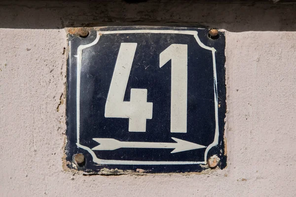 Weathered grunge square metal enameled plate of number of street address with number 41
