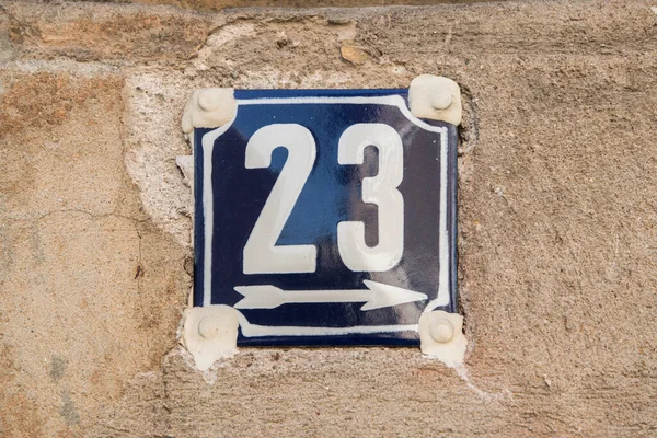 Weathered grunge square metal enameled plate of number of street address with number 23