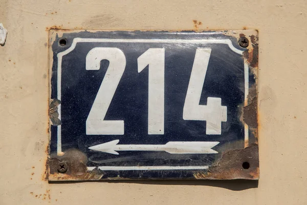 Weathered grunge square metal enameled plate of number of street address with number 214