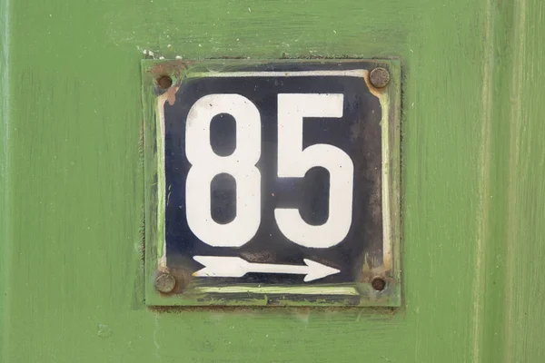 Weathered grunge square metal enameled plate of number of street address with number 85