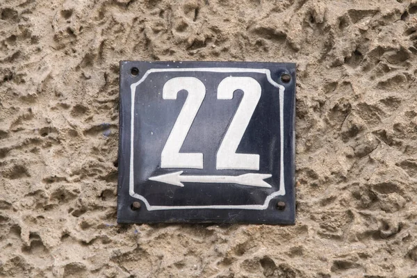 Weathered grunge square metal enameled plate of number of street address with number 22