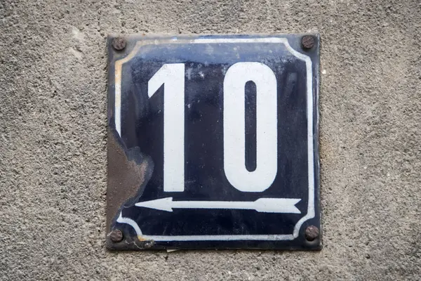 Weathered grunge square metal enameled plate of number of street address with number 10
