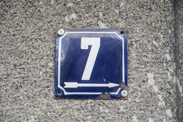Weathered grunge square metal enameled plate of number of street address with number 7