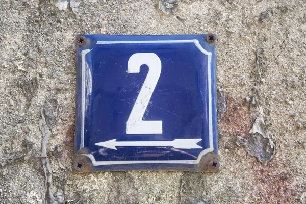 Weathered grunge square metal enameled plate of number of street address with number 2