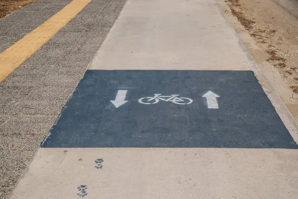 stock image Bicycle lane on the road in the park closeup