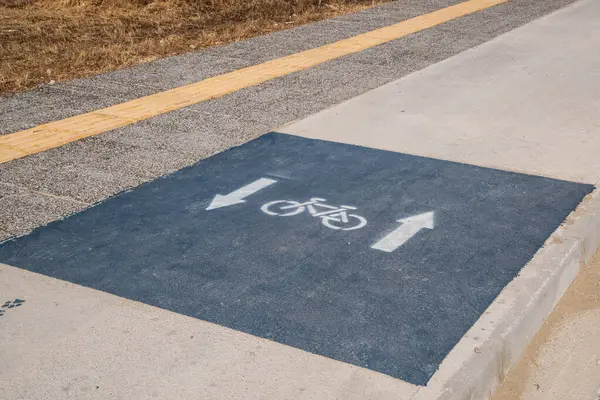 stock image Bicycle lane on the road in the park closeup