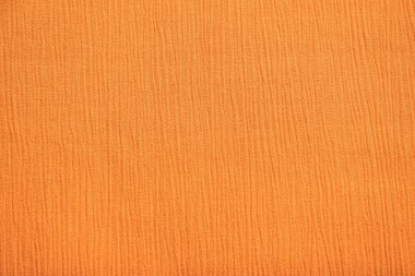 Kremalı turuncu kumaş tekstil arka planı olarak yakın plan