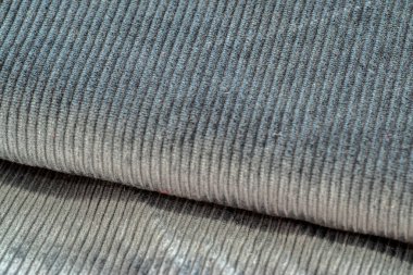 Grey textured corduroy fabric patterns closeup as textile background clipart