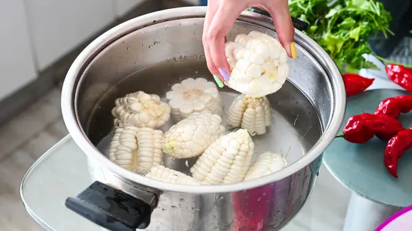 Peruvian corn boiling in a pot, homemade food