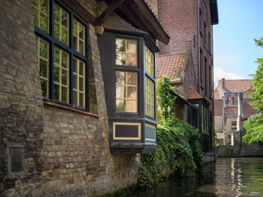 Bruges, Belgium-July 4, 2022: An old house at a canal in Bruges, summer, daylight