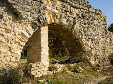 Baharda güneşli bir günde Arles yakınlarında barbekü su kemeri ve değirmenleri. Bu Roma kompleksi bir su kemeri ve iki paralel sekiz kişilik yamaçtan inen 16 su tekerleğinden oluşuyordu. (Provence, Fransa)